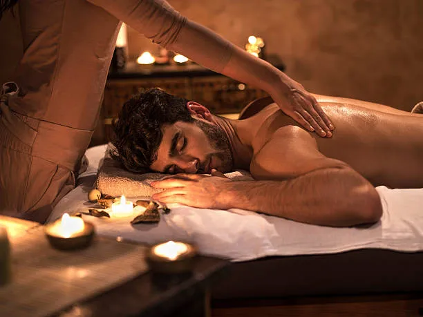 Cliente en sesión de masaje tántrico ambientado con velas